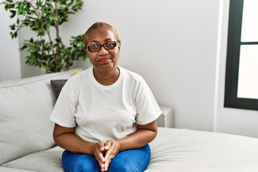 Mature,Hispanic,Woman,Sitting,On,The,Sofa,At,Home,Depressed