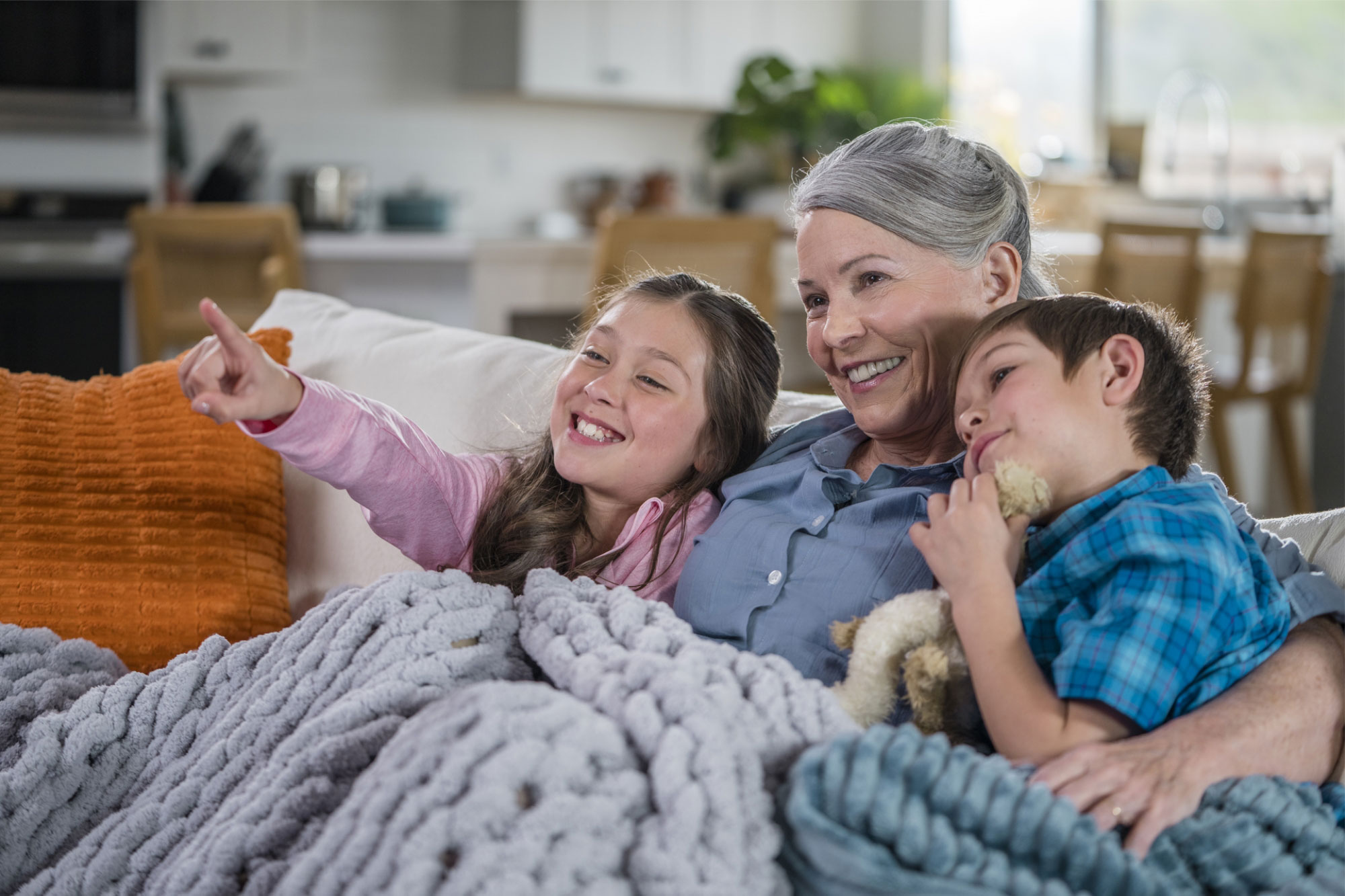 beltone serene lifestyle grandmother with grandkids watching tv