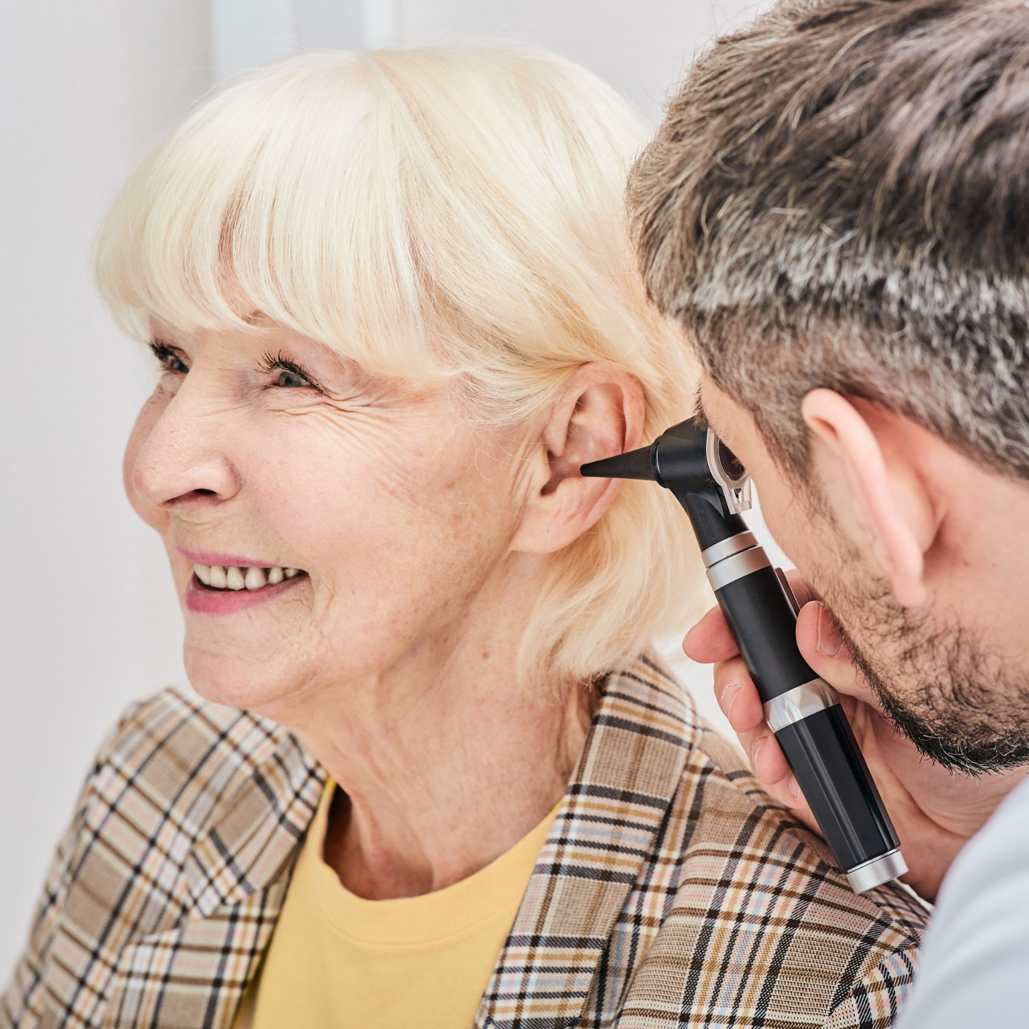 hearing care provider evaluating ear canal square