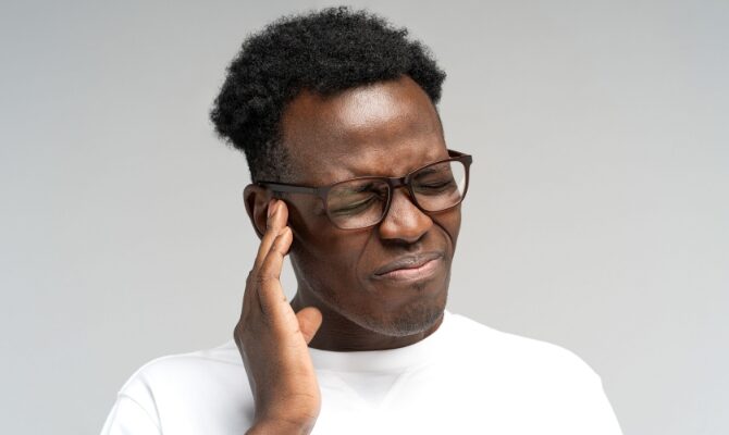 male suffering from ringing in ears tinnitus