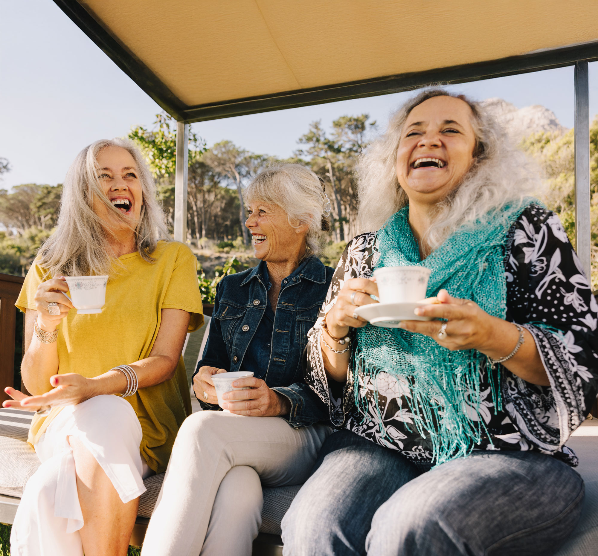 senior friends enjoying tea on patio