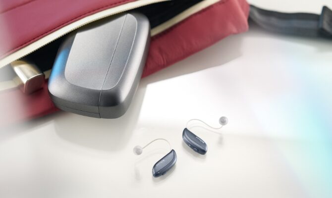 resound vivia hearing aid charger on table purse
