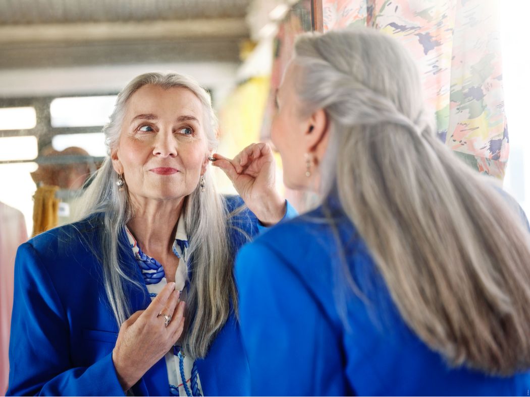 women putting in hearing aid