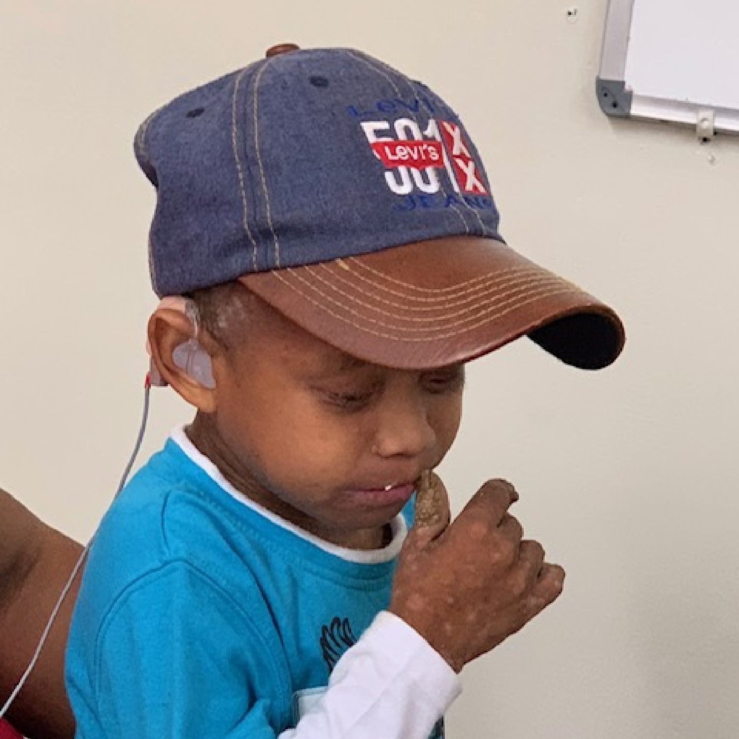 mission trip young boy hearing aid exam