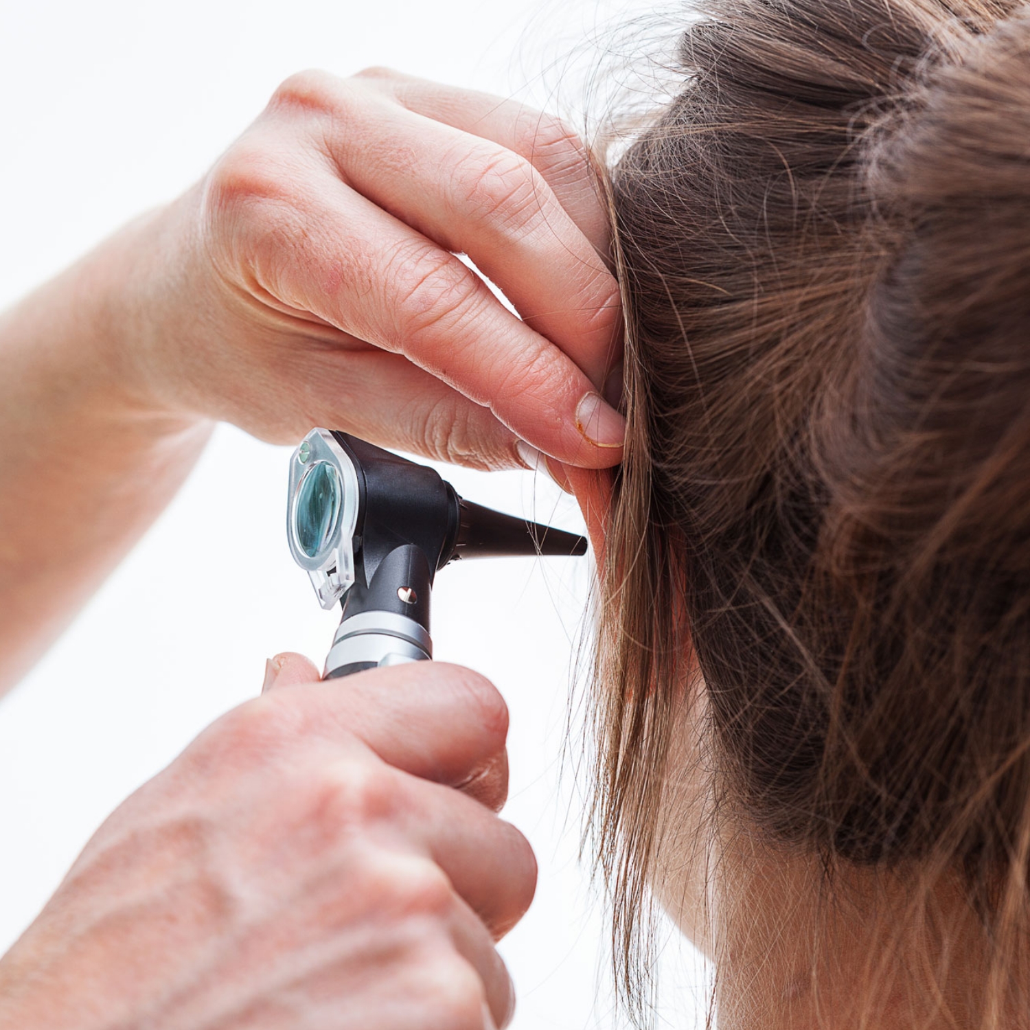 woman ear audiologist inspection otoscope