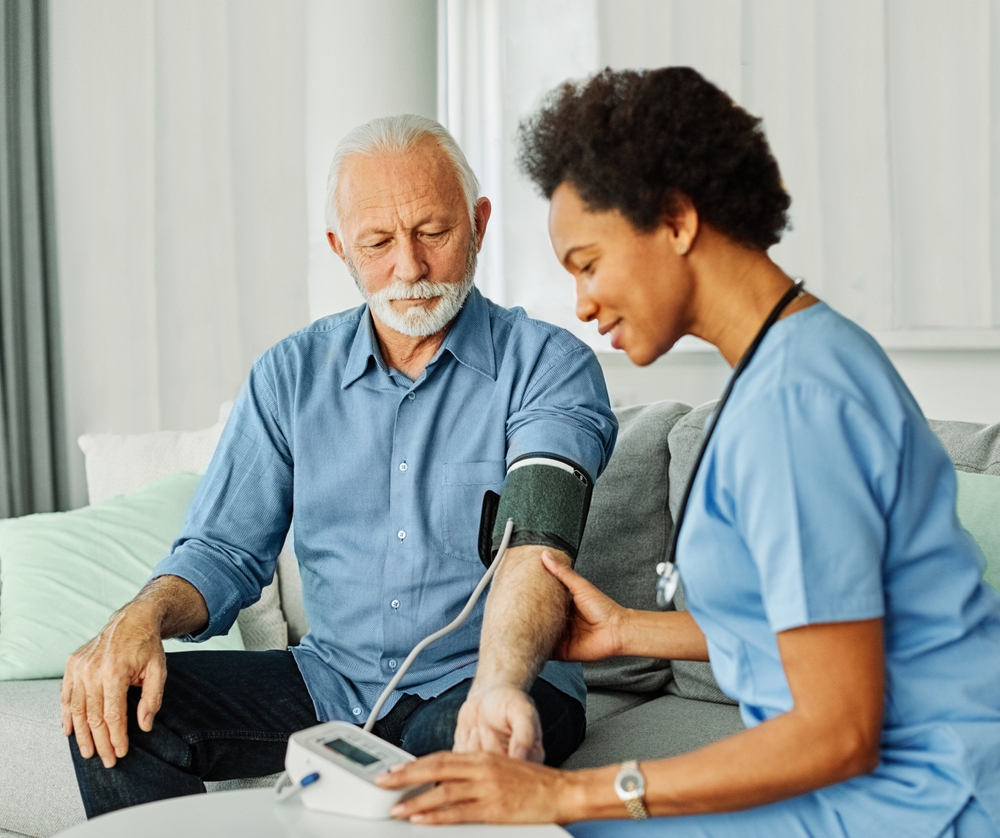 Doctor,Or,Nurse,Caregiver,With,Senior,Man,Using,Blood,Pressure