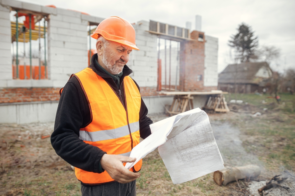 Senior,Man,Engineer,Or,Construction,Worker,In,Hardhat,Looking,At