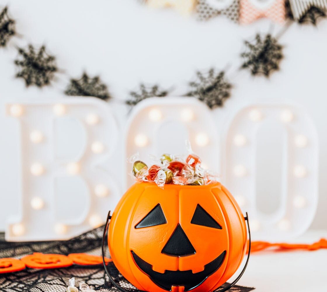 halloween home decoration with pumpkin basket filled with candies