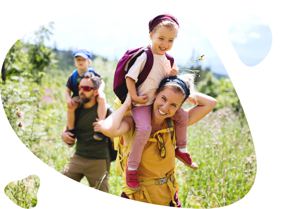 Family with small children hiking outdoors in summer nature