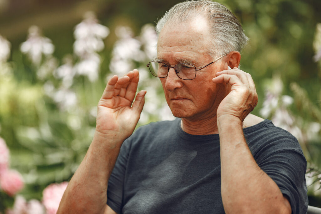 Portrait of happy handsome older man using smartphone