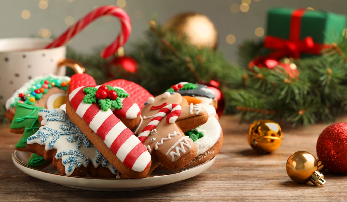 blog baking plate full of decorated christmas cookies surrounded by decorations