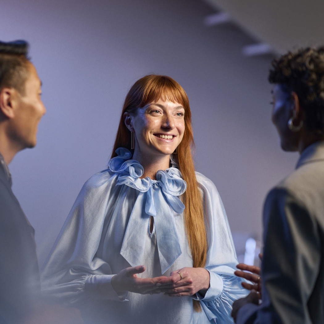 ReSound Vivia lifestyle hearing aid users talking in small group smiling