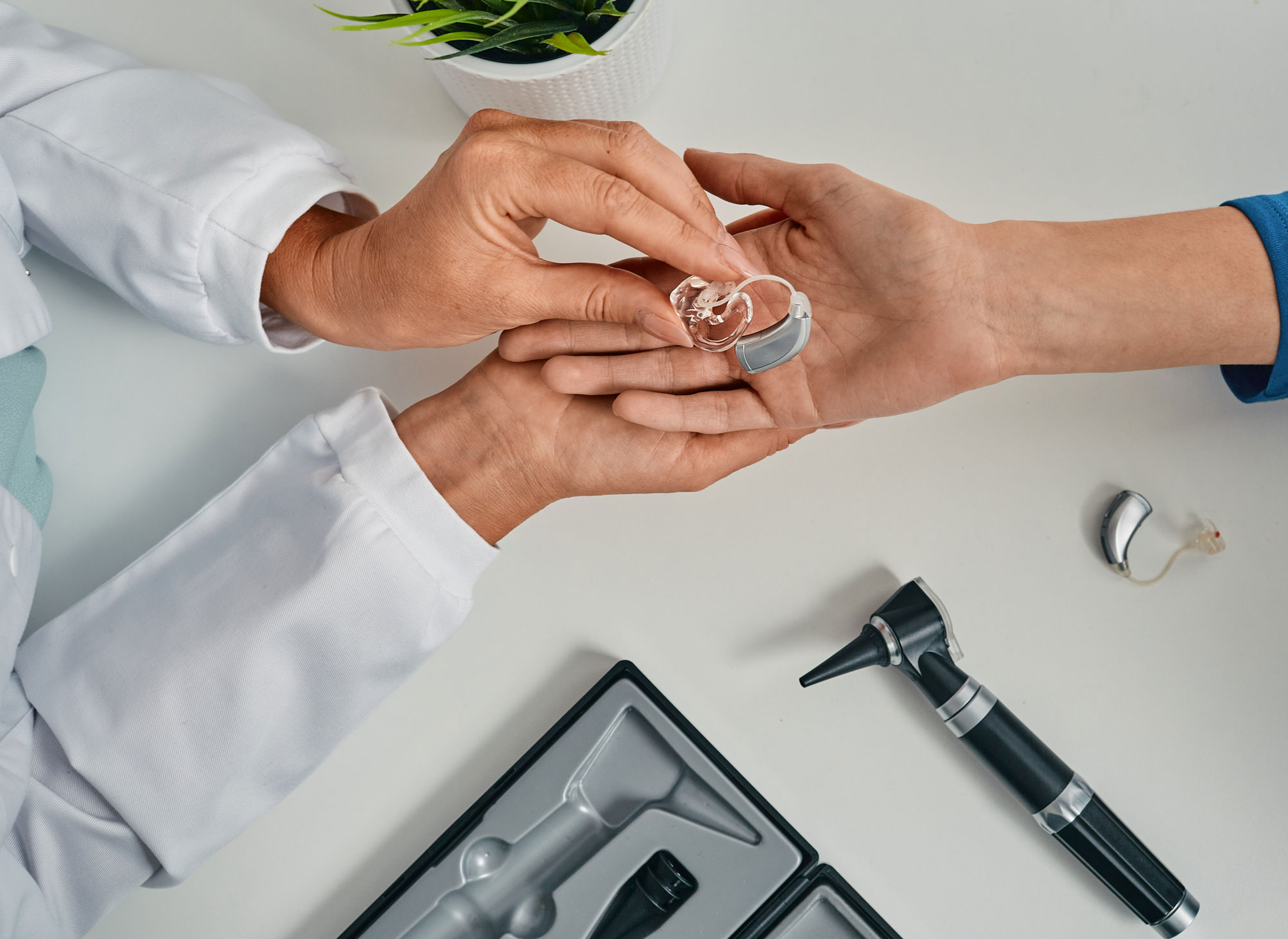 audiologist showing patient hearing aids