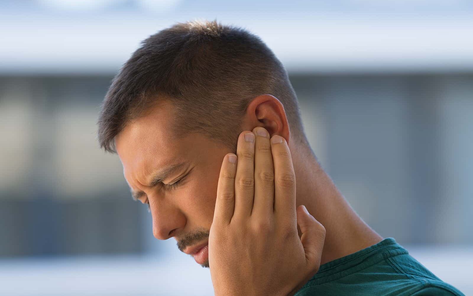 bigstock Young Man With Earache Otitis 437264858