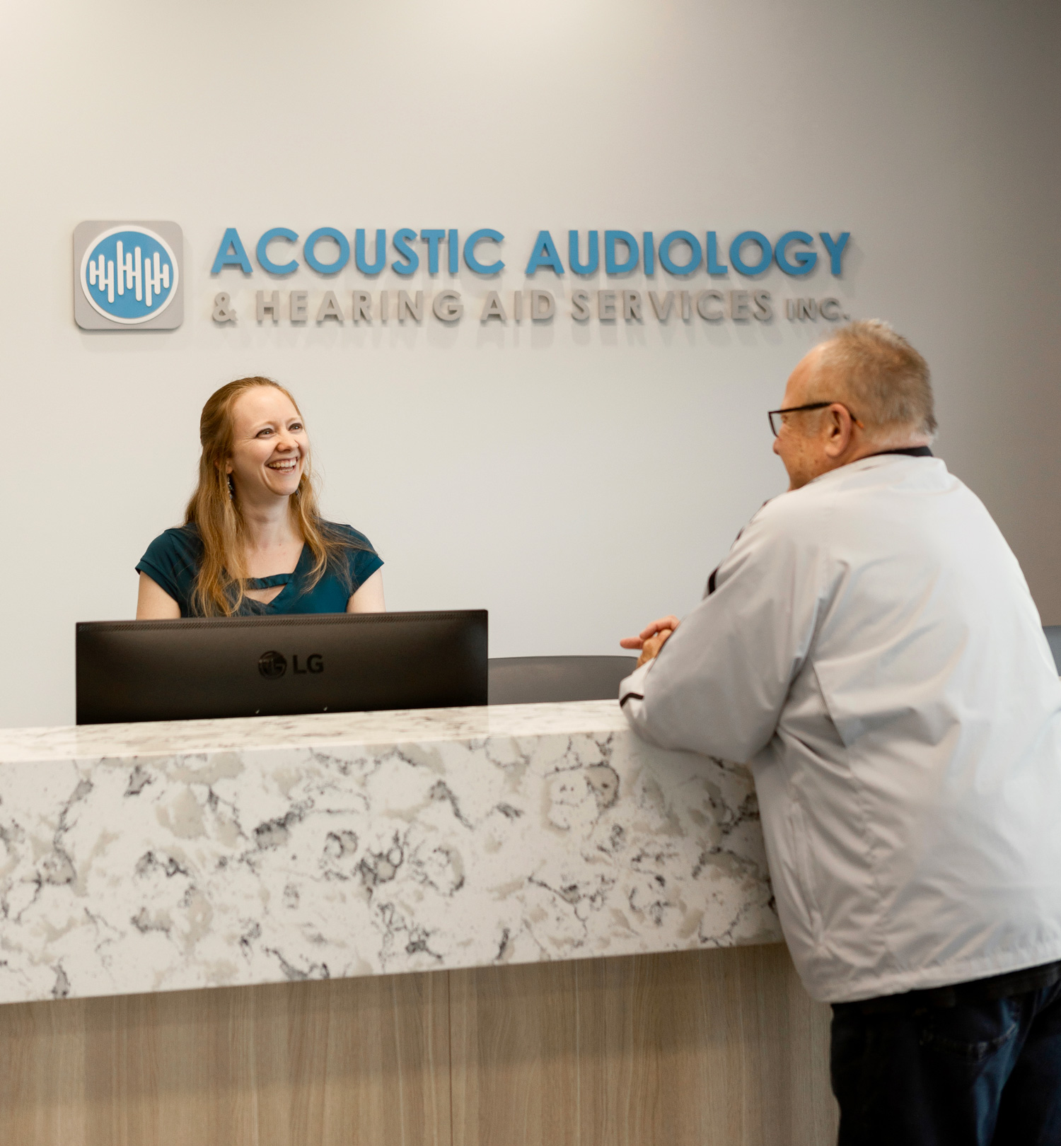 acoustic audiology front staff greeting male patient