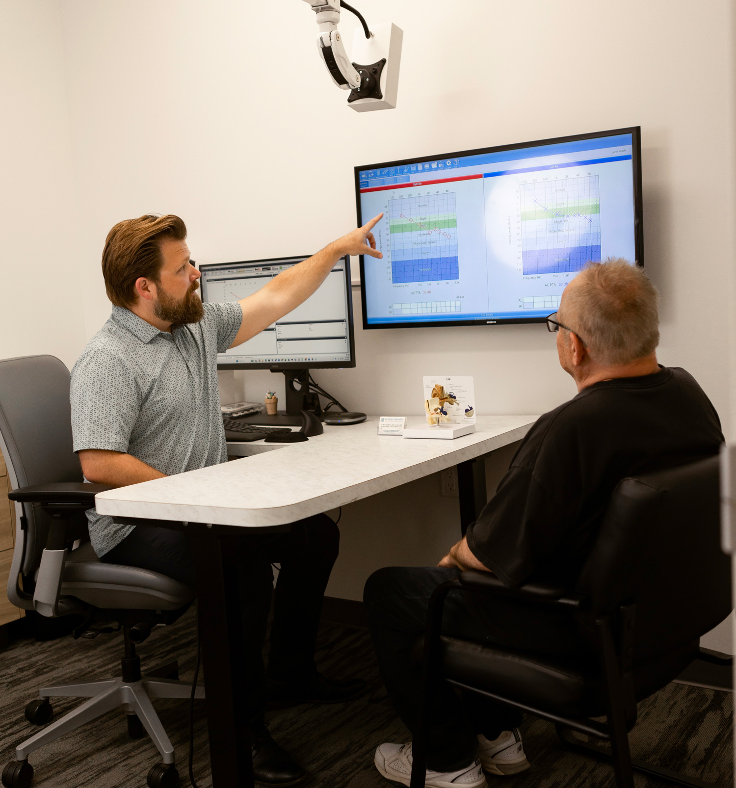 acoustic audiology terry showing results to senior man