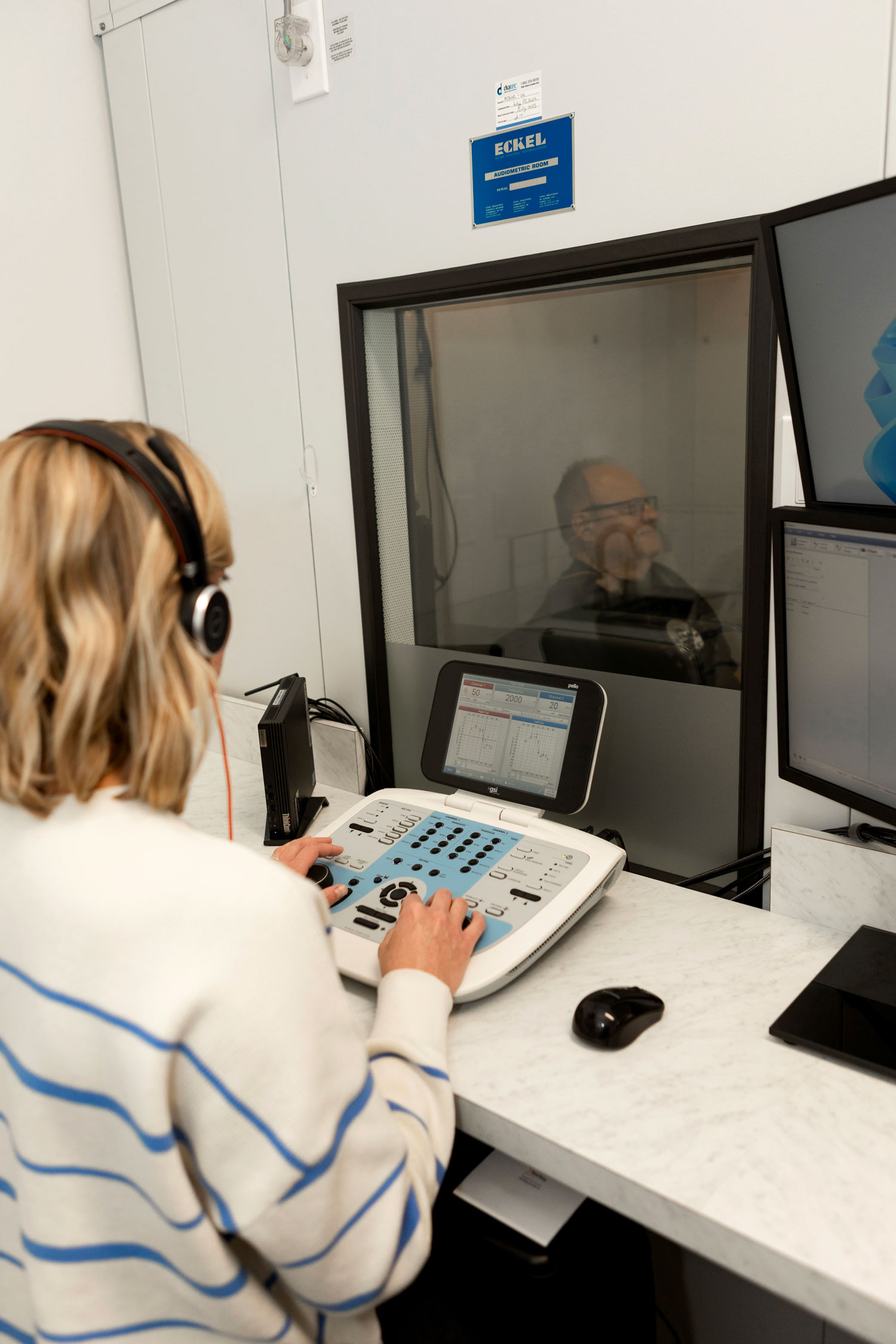 acoustic audiology man taking hearing test in sound booth