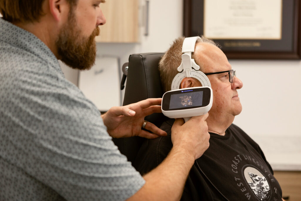 acoustic audiology terry sokalofsky looking in senior mans ear