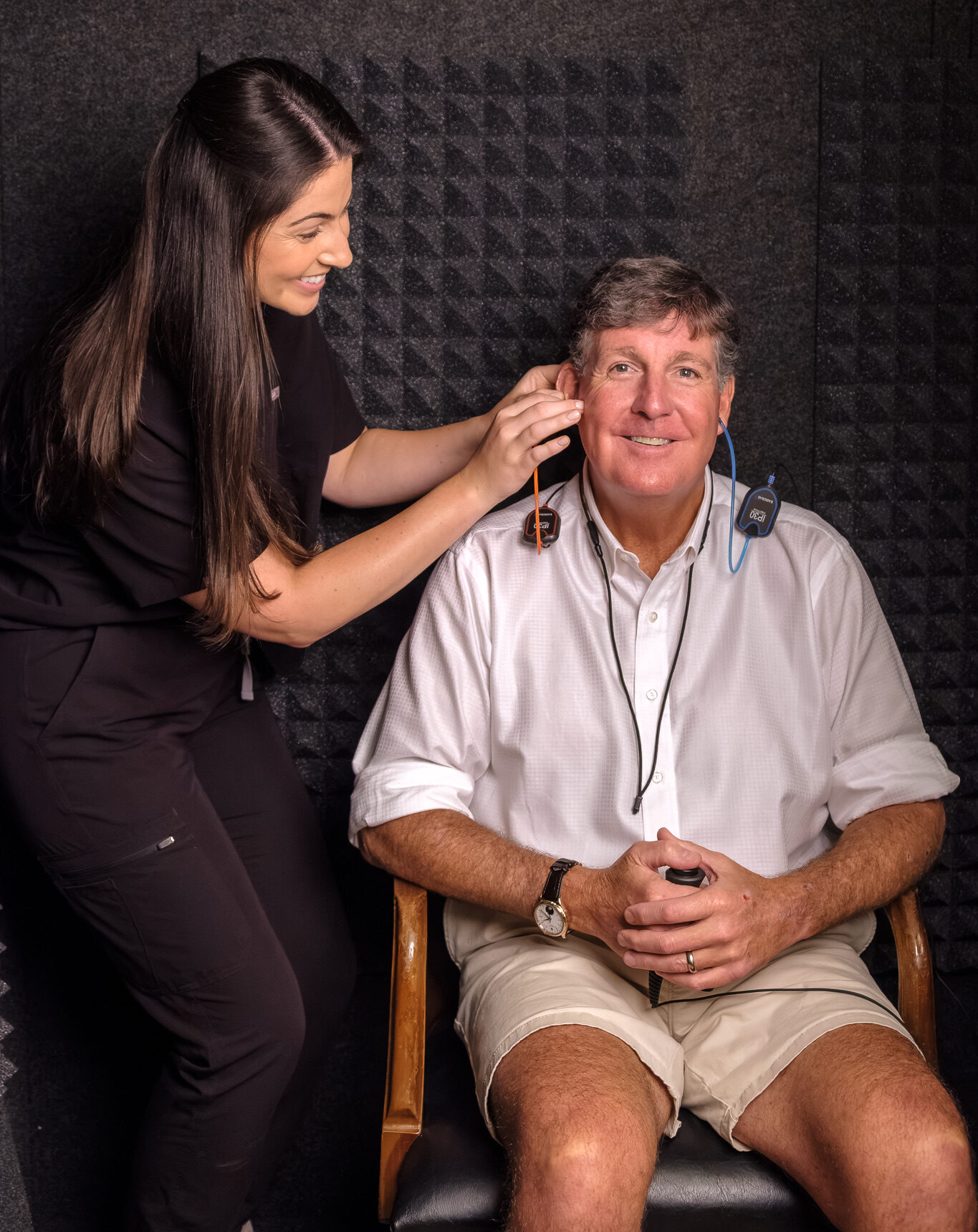 maddie preparing man to take hearing test in sound booth