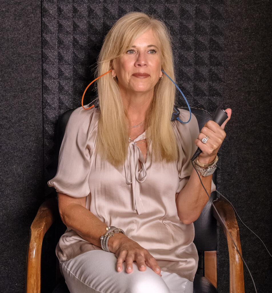 woman taking hearing test in sound booth