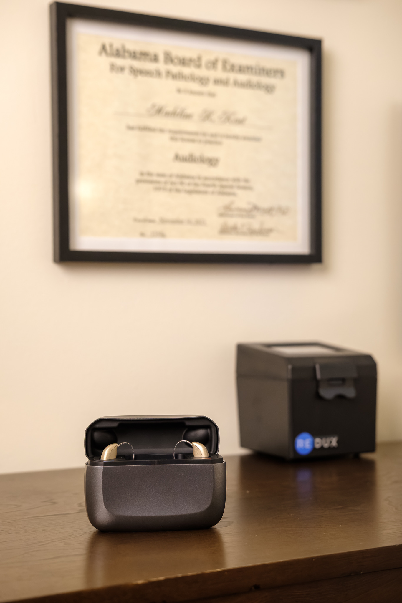 hearing aids in charger next to redux