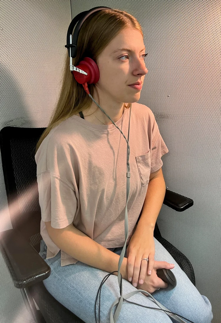 woman taking hearing test in sound booth
