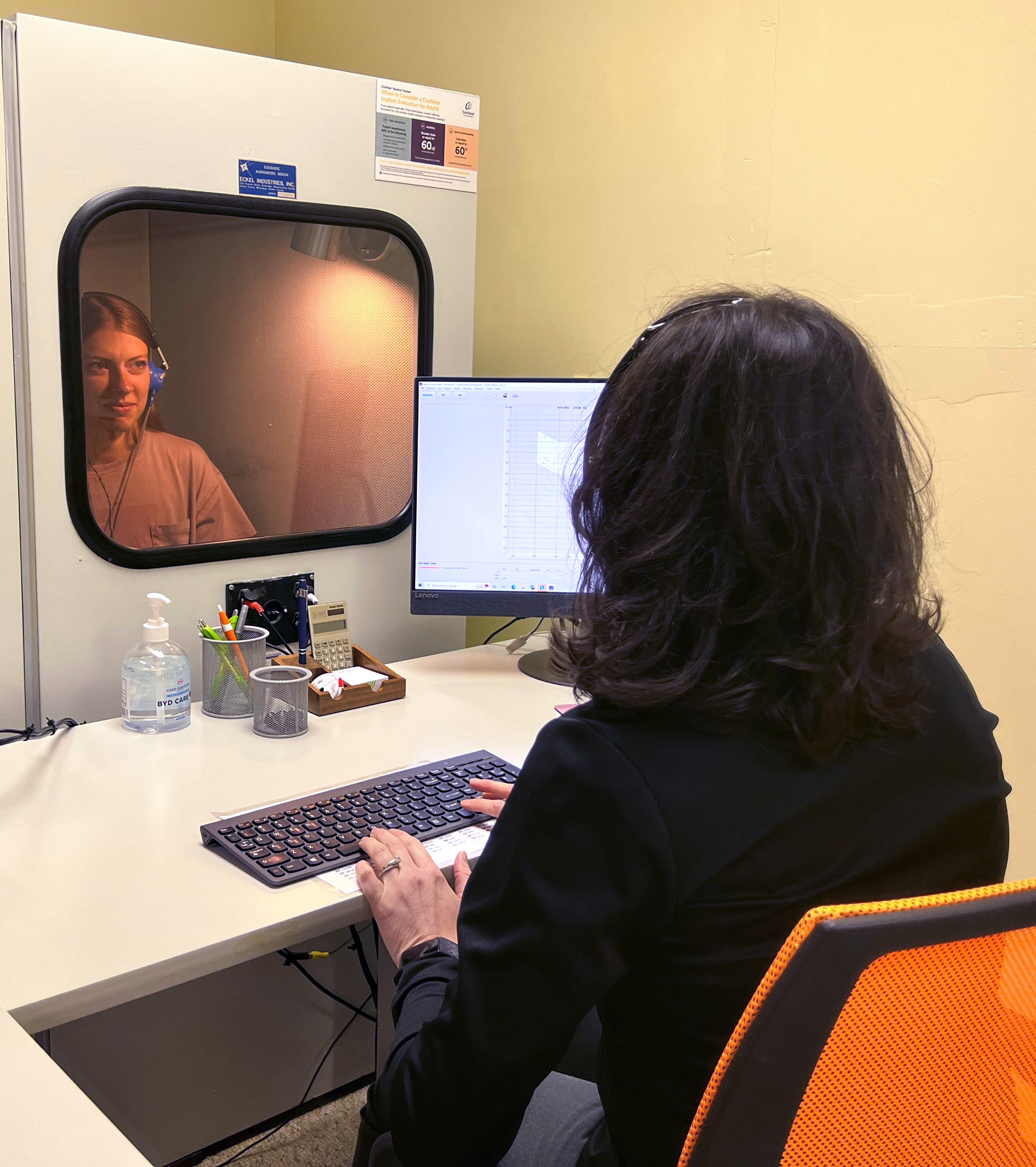 dr andi performing hearing test in sound booth