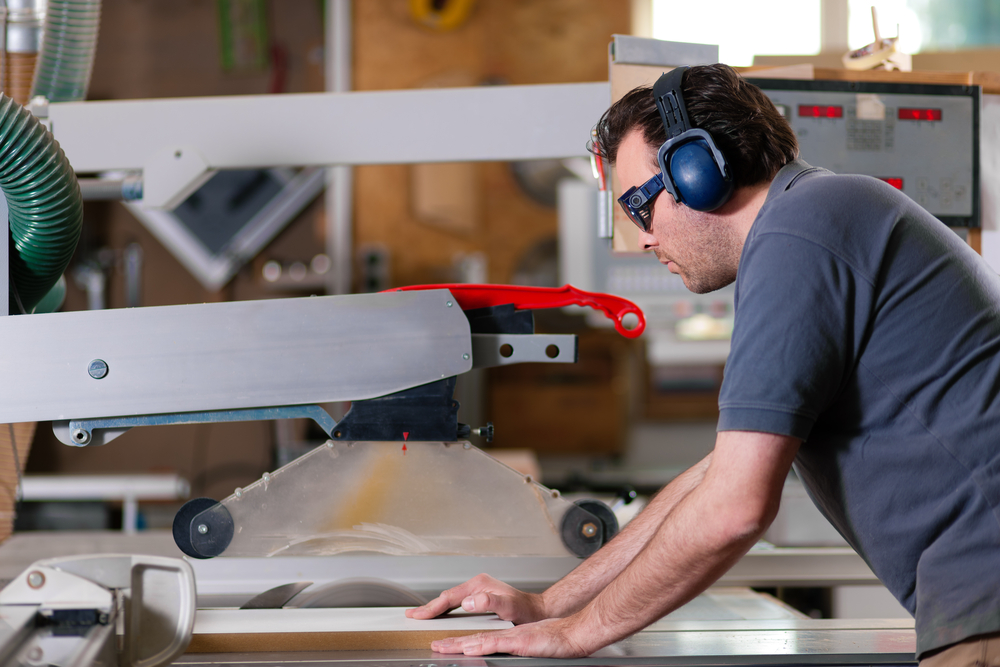 Carpenter,Working,On,An,Electric,Buzz,Saw,Cutting,Some,Boards,