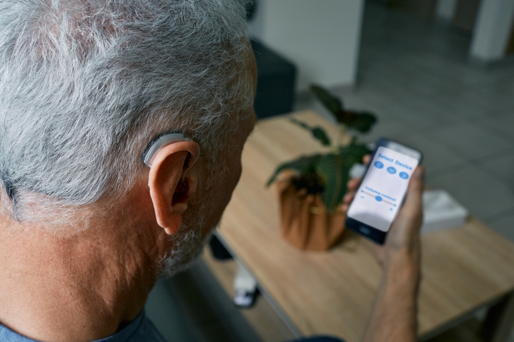 Hearing,Impaired,Senior,Man,Adjusting,Settings,For,His,Bte,Hearing