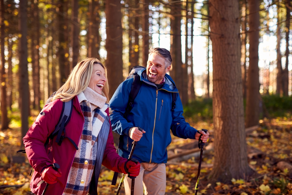 Side,View,Of,Mature,Retired,Couple,Walking,Through,Fall,Or