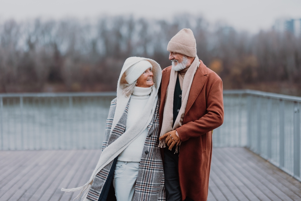 Elegant,Senior,Couple,Walking,Near,The,River,,During,Cold,Winter