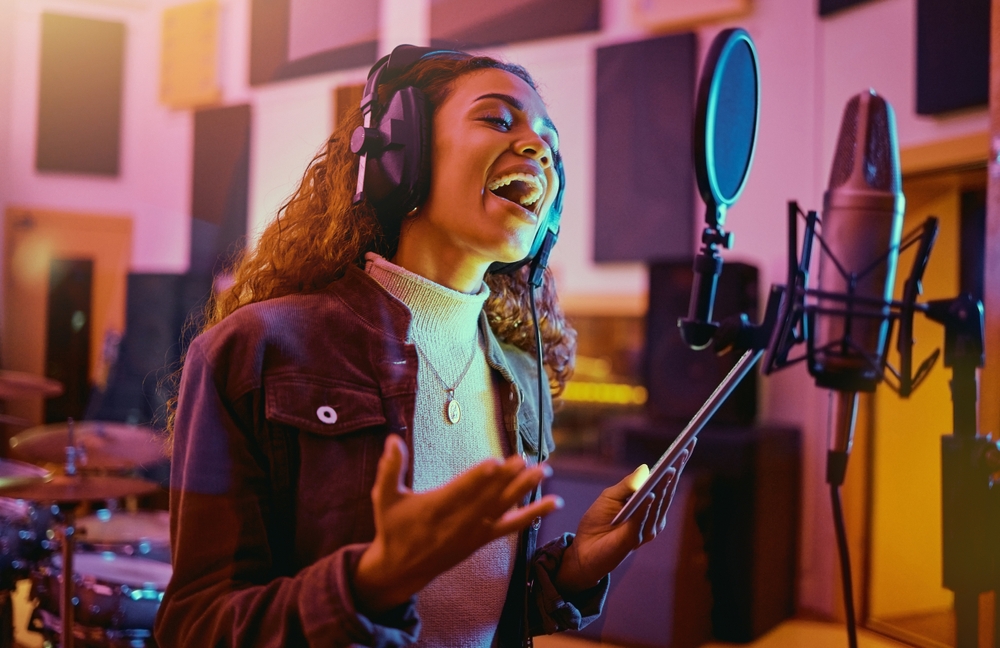 Tablet,,Music,And,Woman,Singing,In,A,Studio,For,Radio,