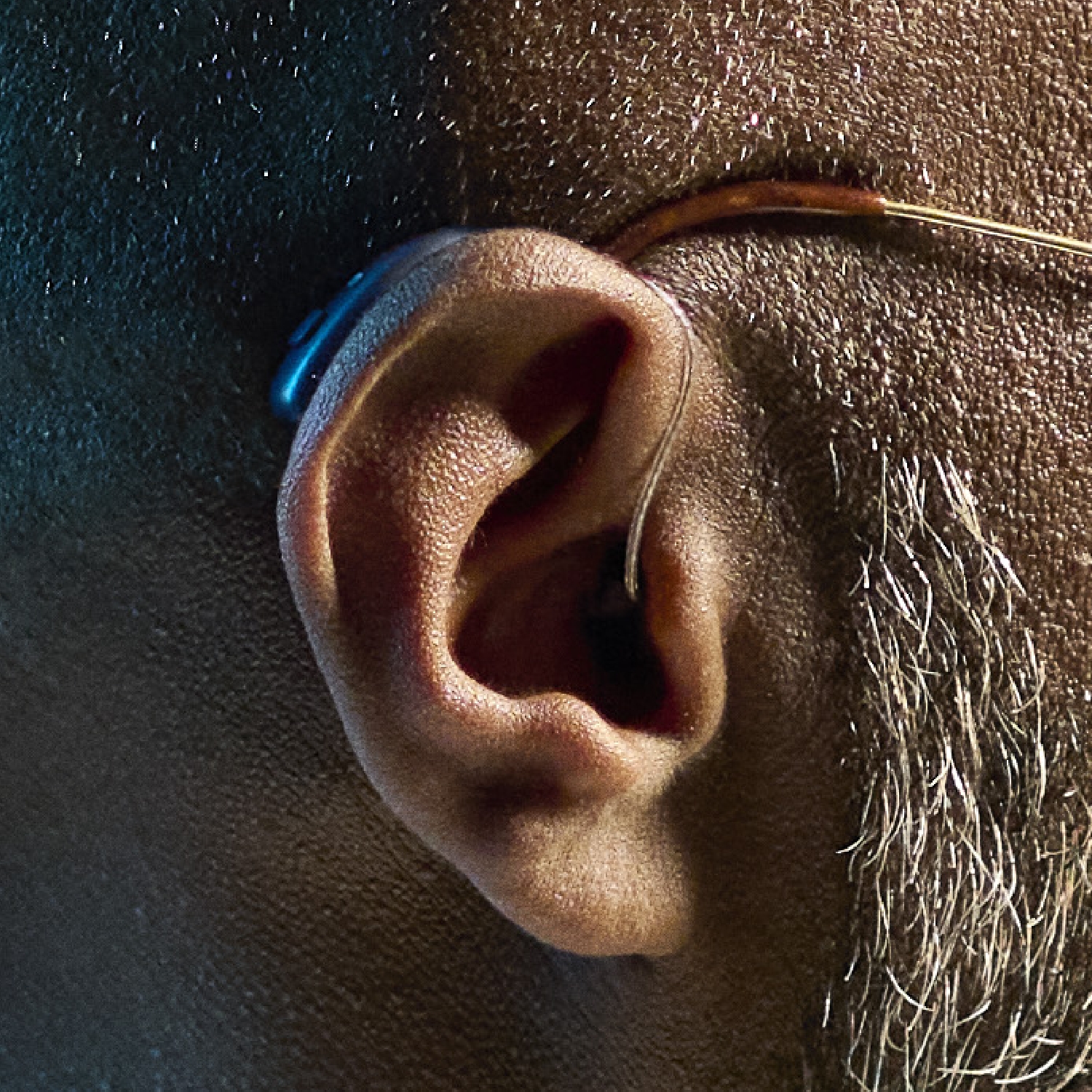 ReSound Vivia bte hearing aid closeup older black male ReSound Vivia bte hearing aid closeup older black male