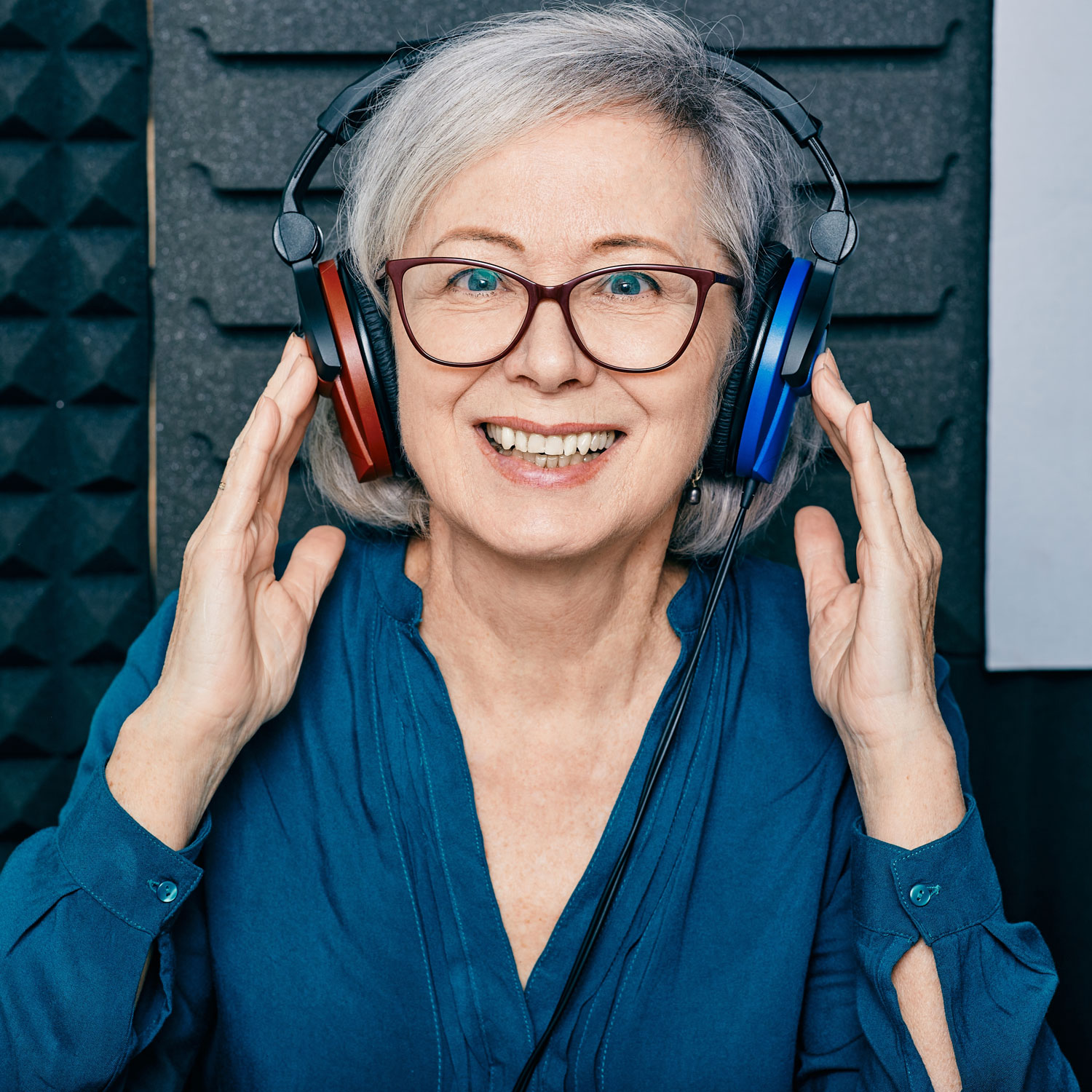 senior woman taking hearing test in sound booth senior woman taking hearing test in sound booth