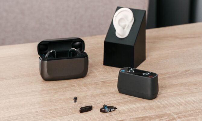cta stacked hearing aids on table with charging case