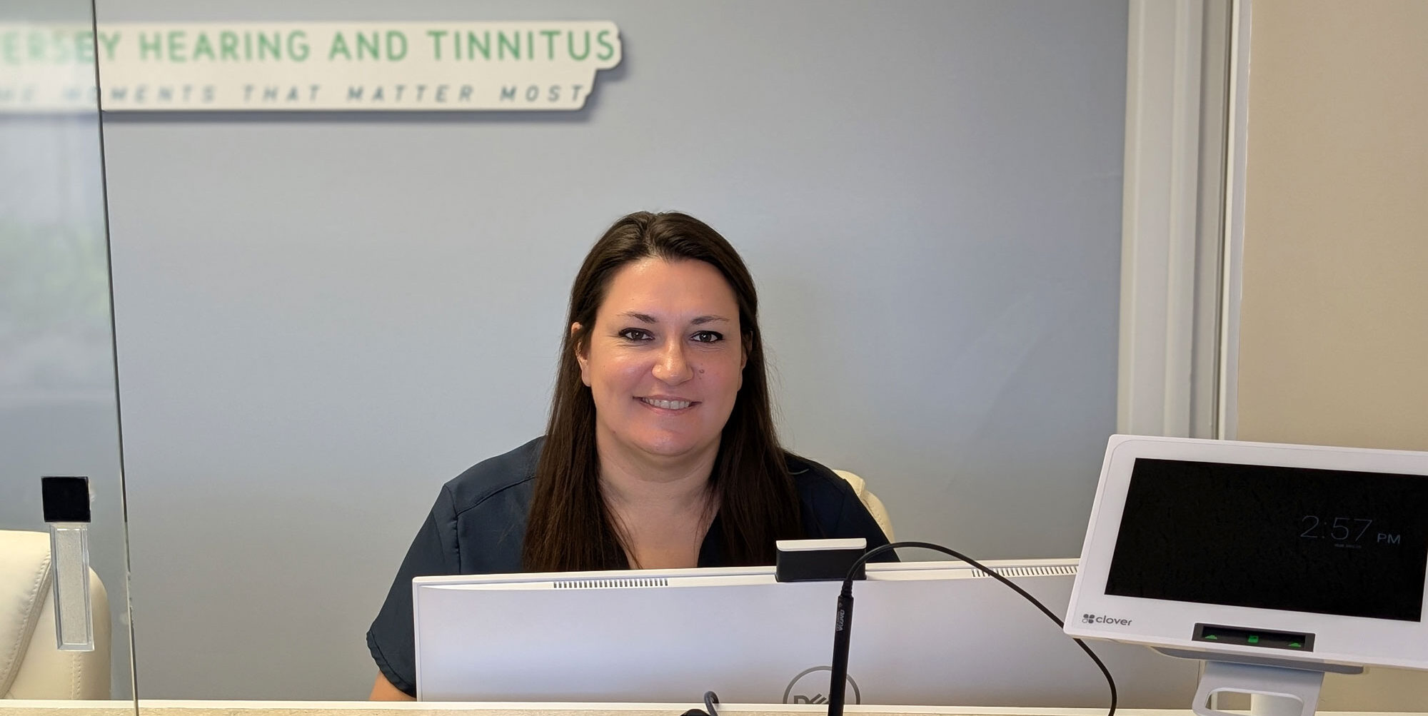 Kelli Shivers Beswick Au D at front desk smiling cropped