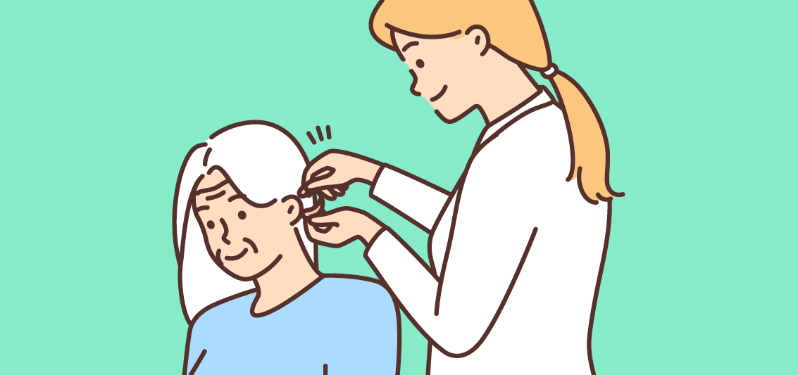 Person fitting a hearing aid for an older adult with white hair against a teal background.