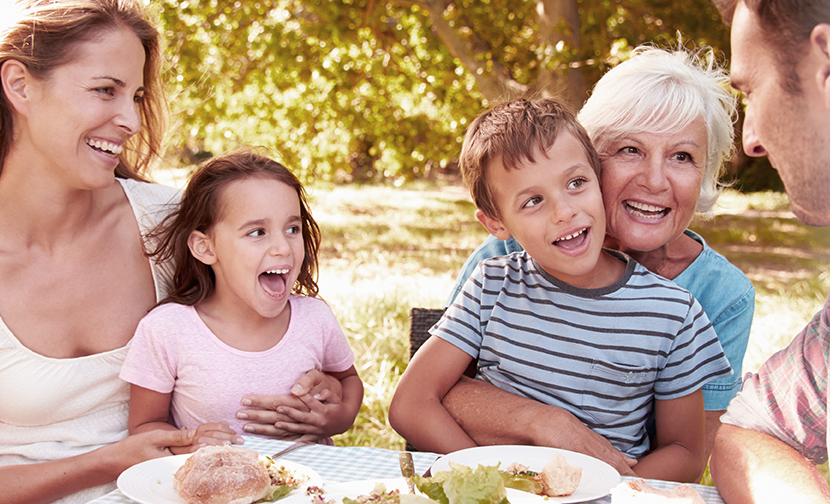 family at outdoor lunch table