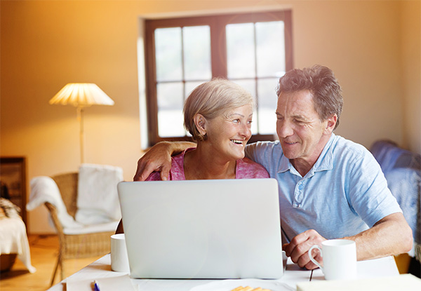 Elderly Couple Using Laptop