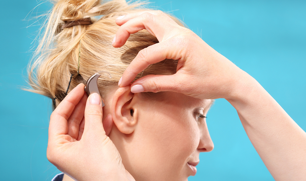 woman getting a hearing aid fitted