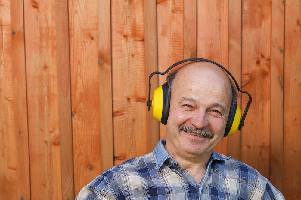 man wearing yellow over-the-head hearing protection