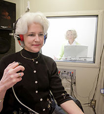 a gentleman getting his ears checked out by a hearing specialist