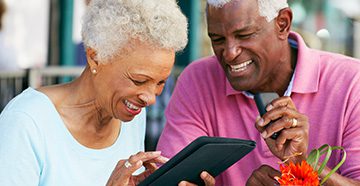 cta couple smiling using tablet 1e