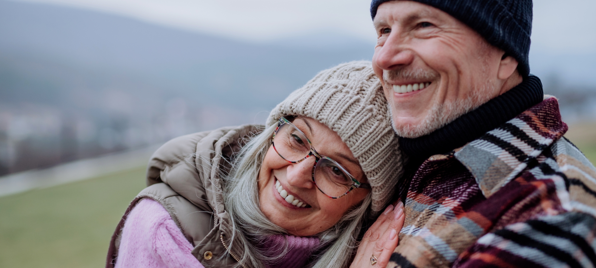 banner seasonal winter mature couple outside hugging smiling banner seasonal winter mature couple outside hugging smiling
