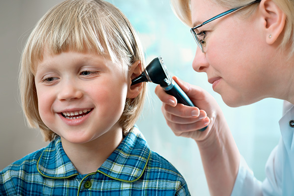 child smiling during his hearing test