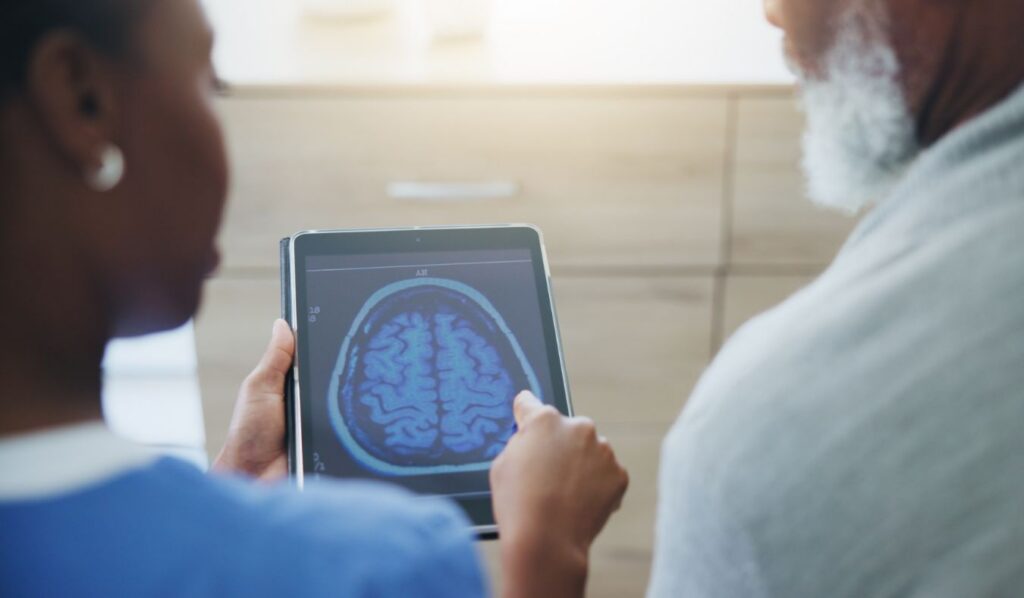 dementia doctor showing brain xray to patient