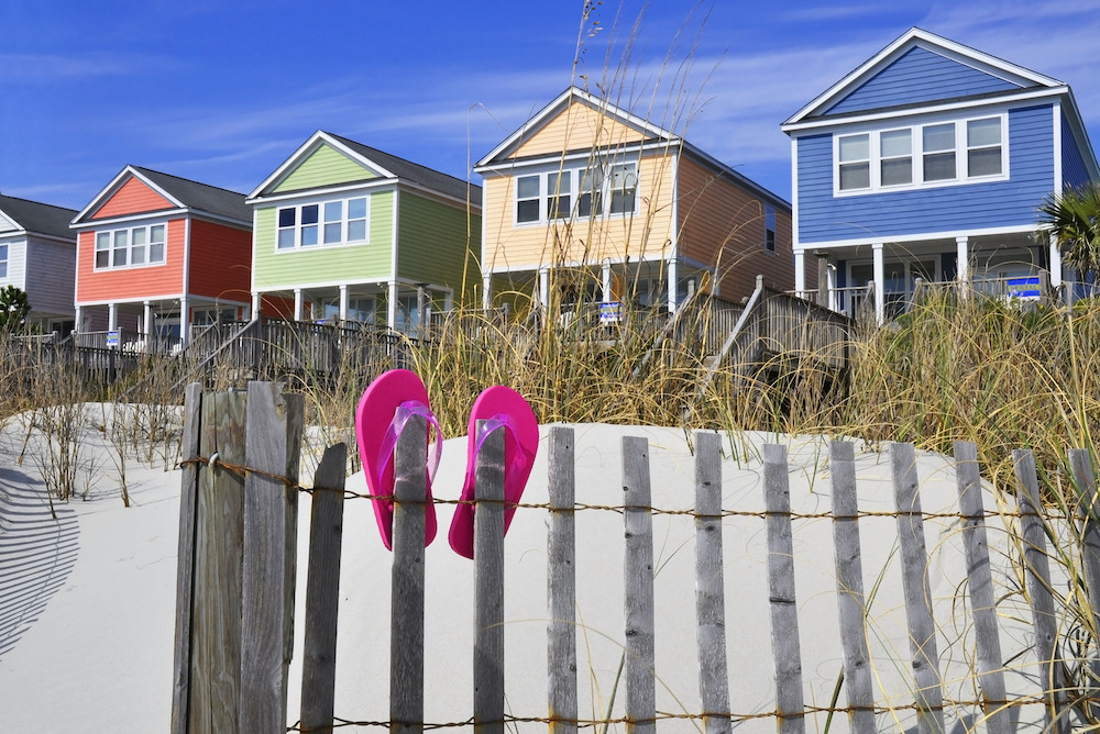 beachfront houses with white sand and pink sandals