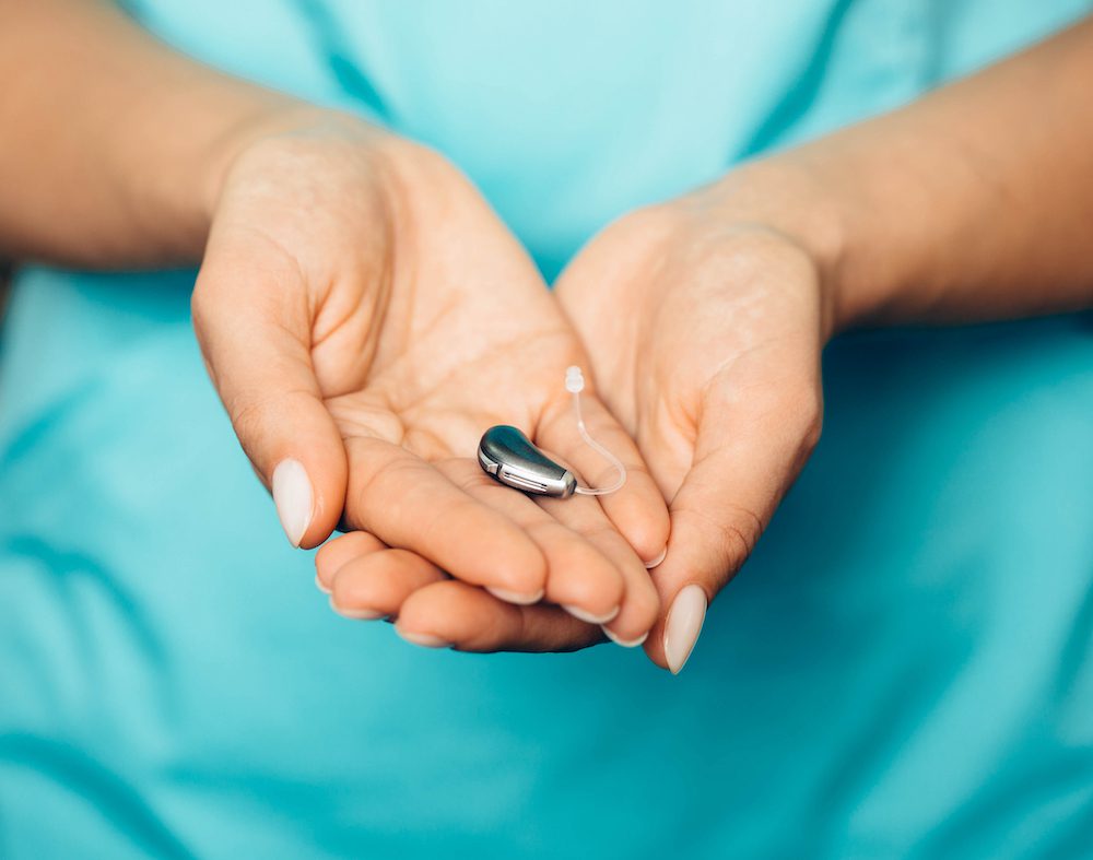 hearing aid held in palm of hand