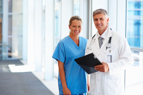 two doctors standing a well-lit medical facility