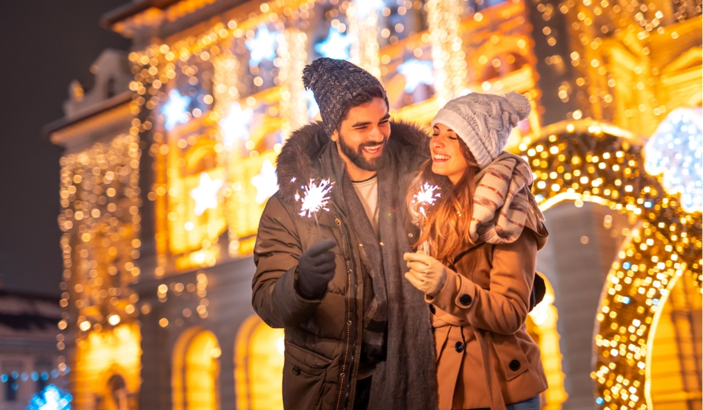 events new years couple celebrating new years outside holiday lights